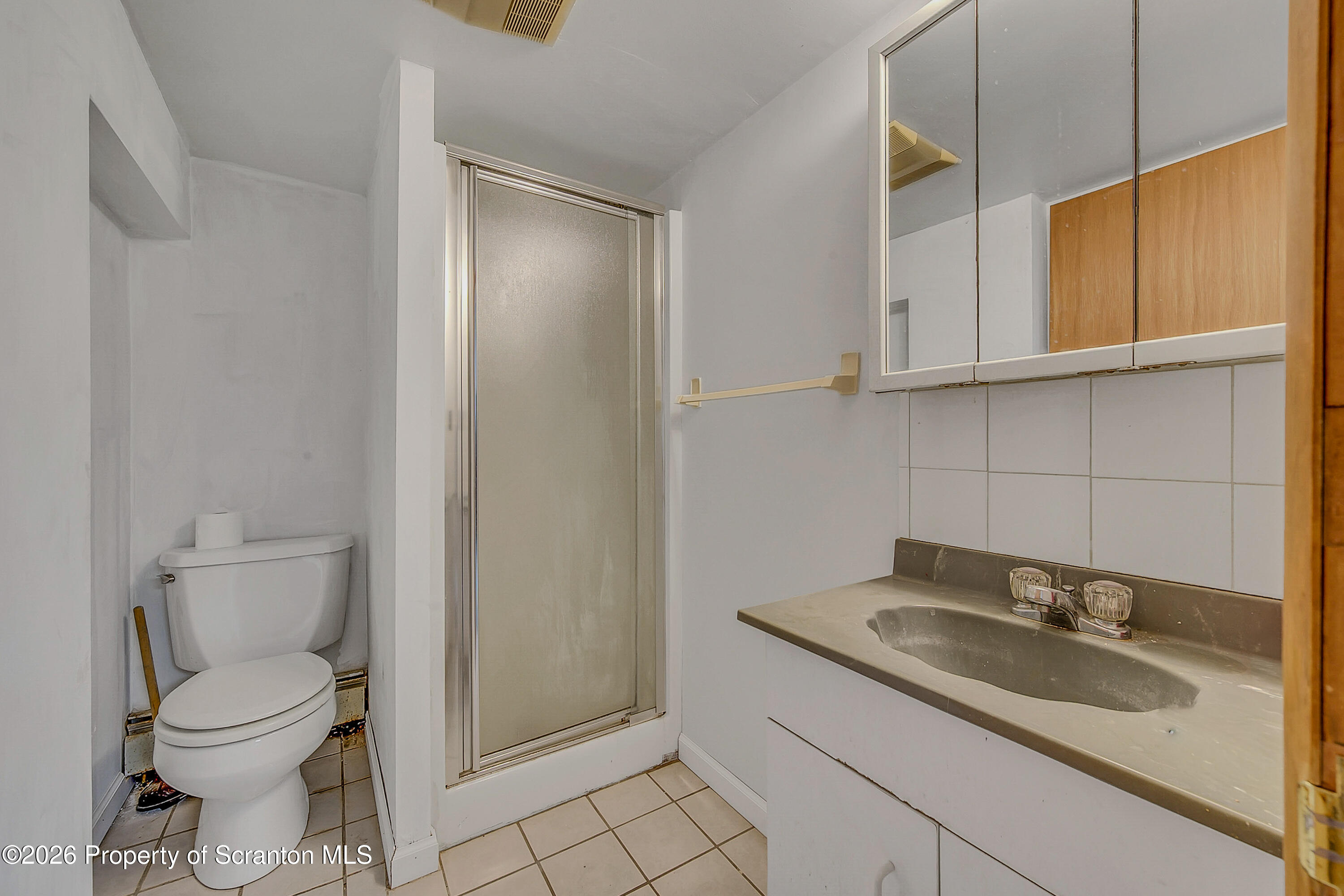 1050 Mark Avenue Dunmore, PA 18510 - Photo 29 of 35 a bathroom with a sink a toilet and mirror
