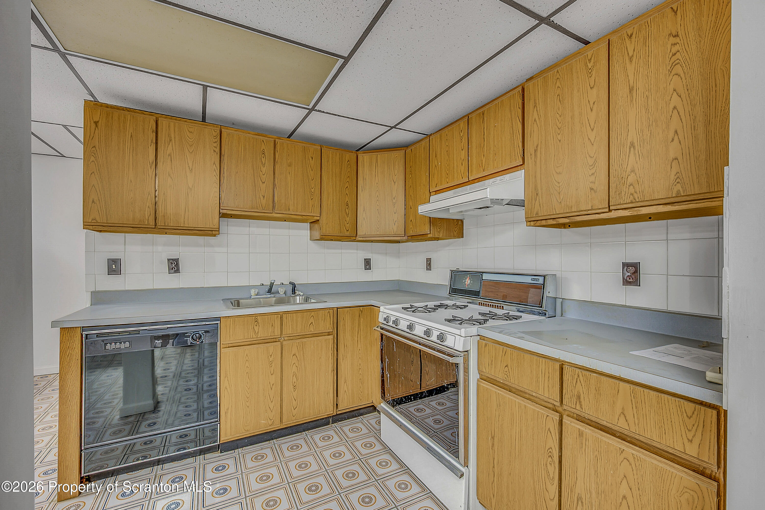1050 Mark Avenue Dunmore, PA 18510 - Photo 32 of 35 a kitchen with stainless steel appliances granite countertop a sink stove and cabinets