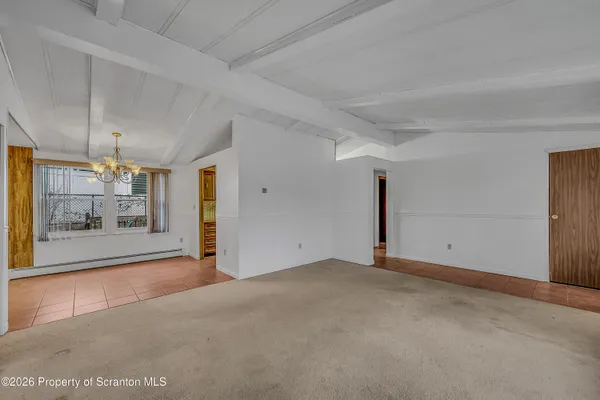 a view of empty room with a fireplace