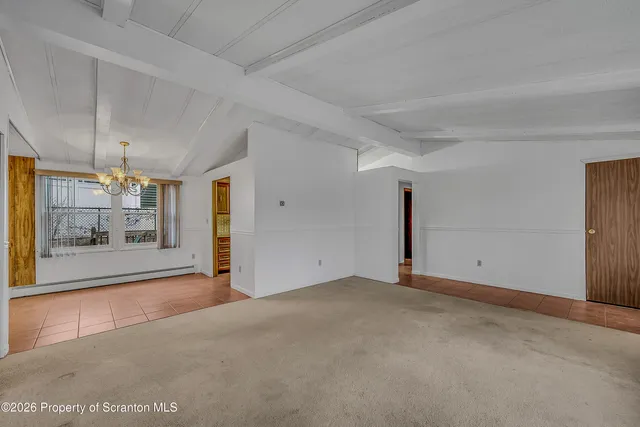 a view of empty room with a fireplace