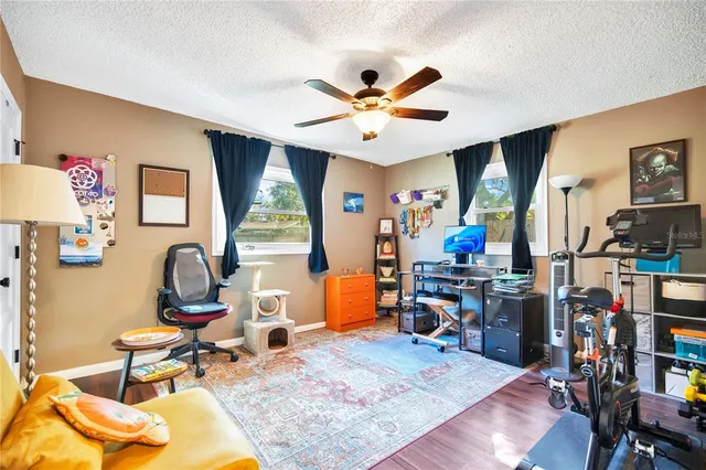 a living room with furniture a piano and a window