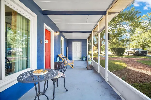 a view of a porch with furniture and yard