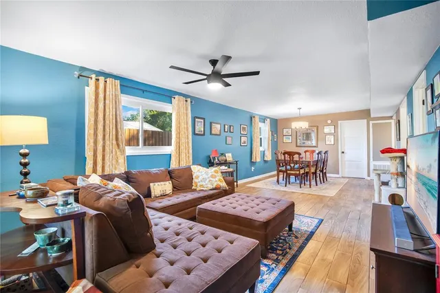 a living room with furniture a rug and a table