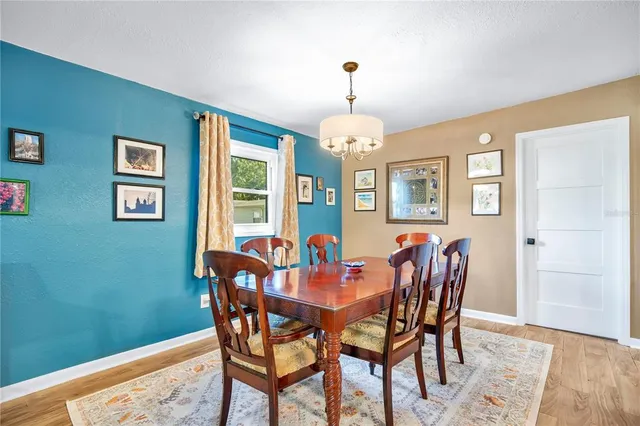 a view of a dining room with furniture and chandelier