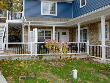 front view of a brick house with a small yard