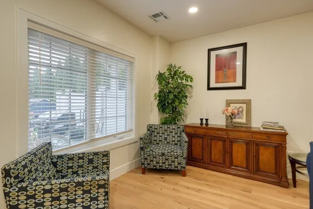 a room with a large window and wooden floor