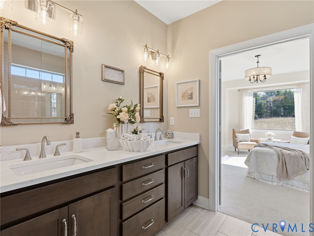 2586 Maidens Road Powhatan, VA 23139 - Photo 16 of 27 a en suite bathroom with a granite countertop sink mirror and double