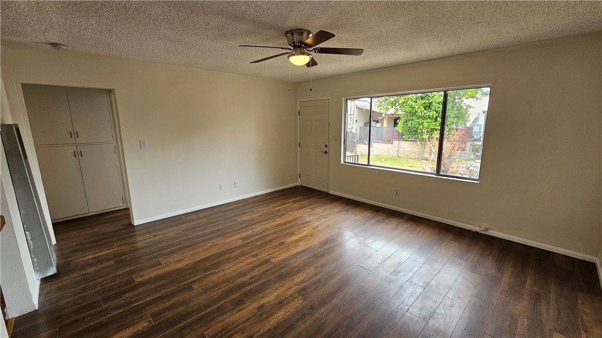 537 Ferris Street Los Angeles, CA 90022 - Photo 4 of 16 a view of an empty room with wooden floor and a window