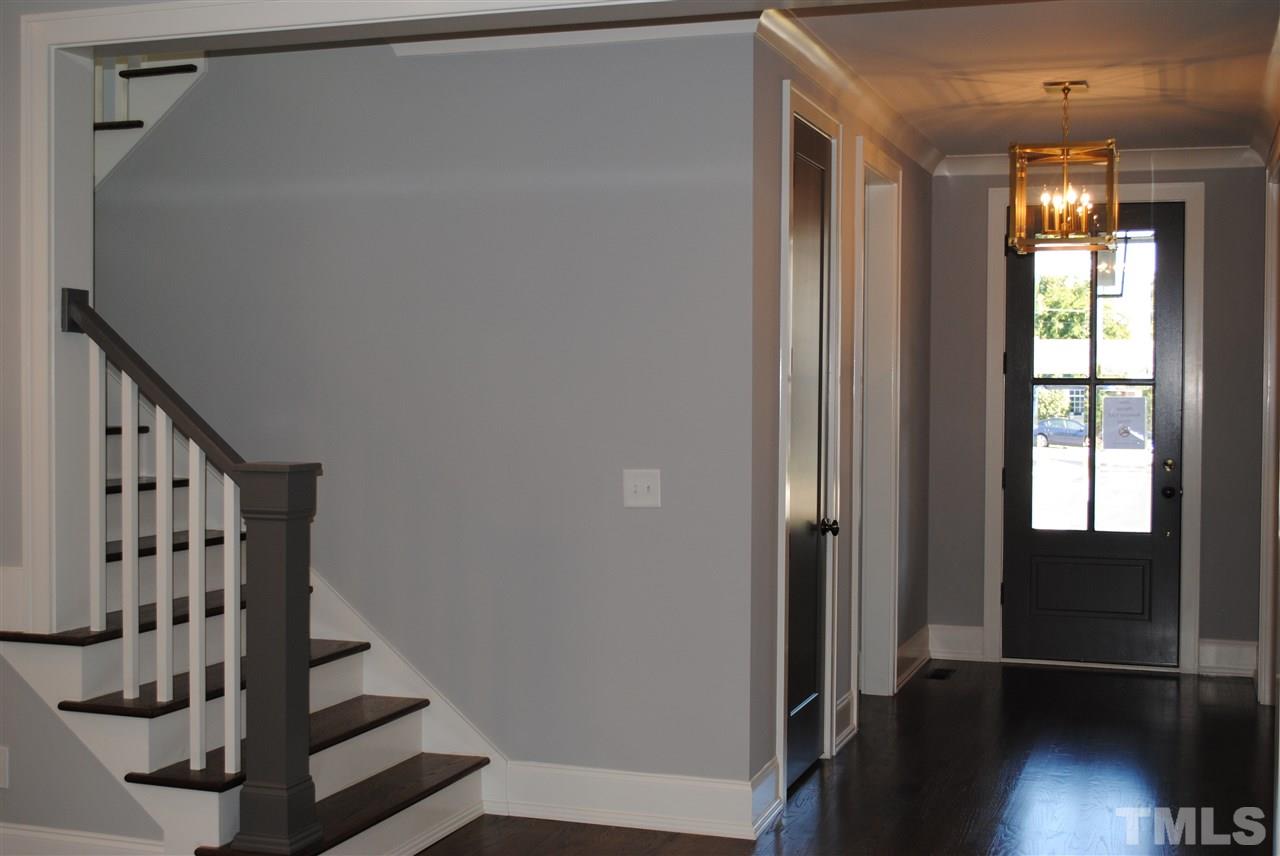 110 Revival Way Raleigh, NC 27608 - Photo 12 of 25 a view of entryway with stairs and wooden floor