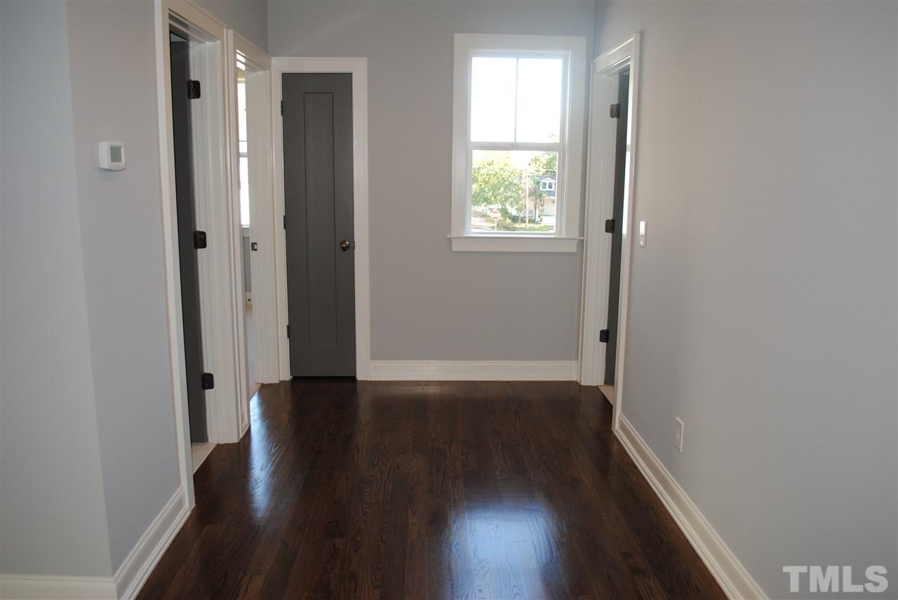 110 Revival Way Raleigh, NC 27608 - Photo 18 of 25 a view of an empty room with wooden floor and a window