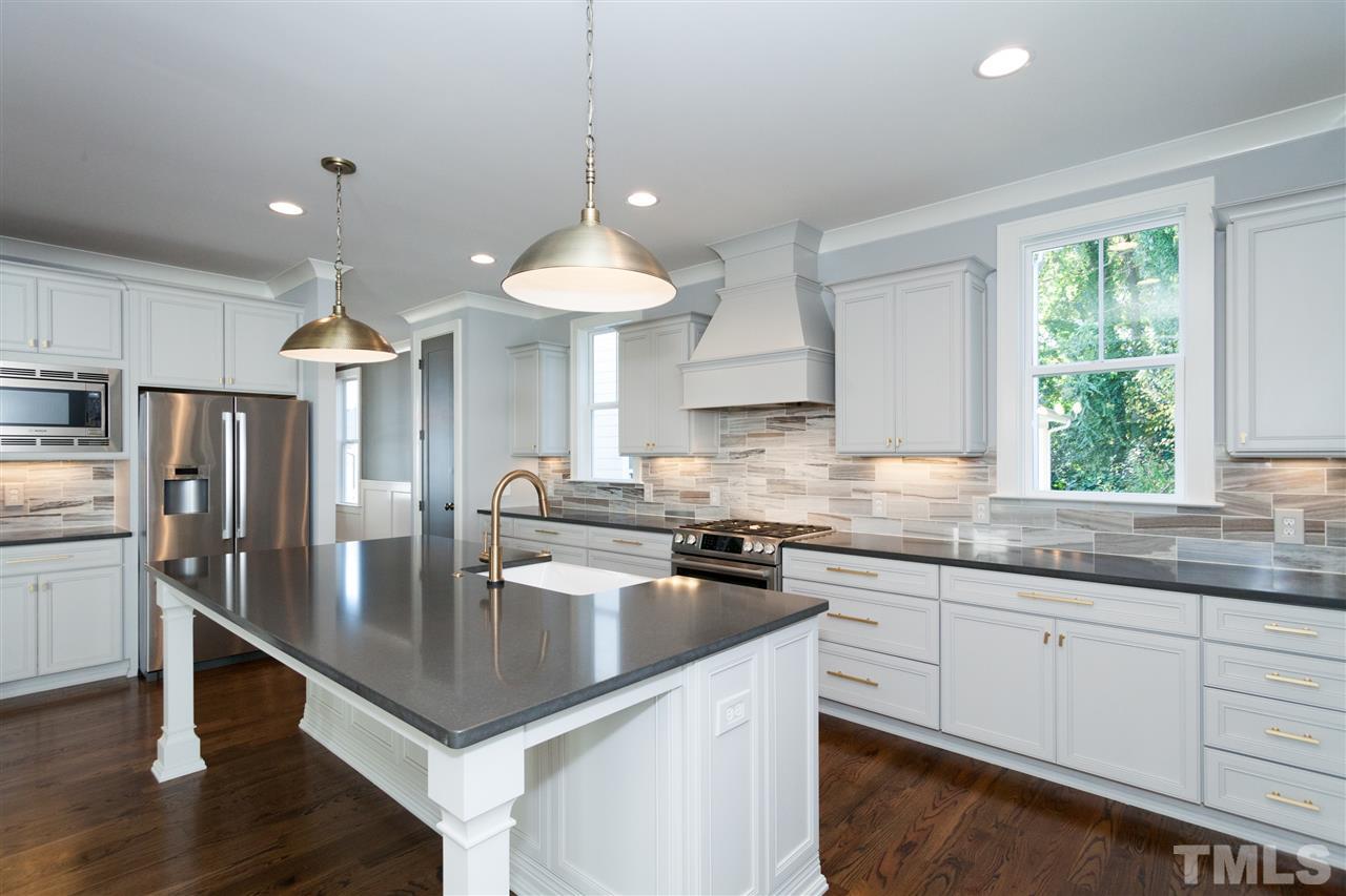 110 Revival Way Raleigh, NC 27608 - Photo 2 of 25 a kitchen with stainless steel appliances granite countertop a sink a stove a refrigerator cabinets and a window