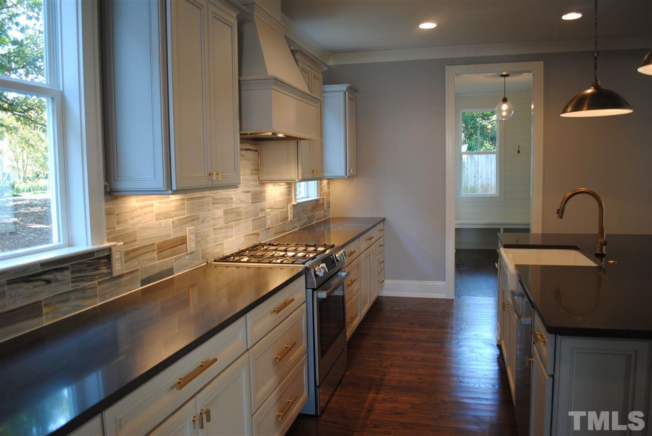 110 Revival Way Raleigh, NC 27608 - Photo 4 of 25 a kitchen with granite countertop a stove and a sink