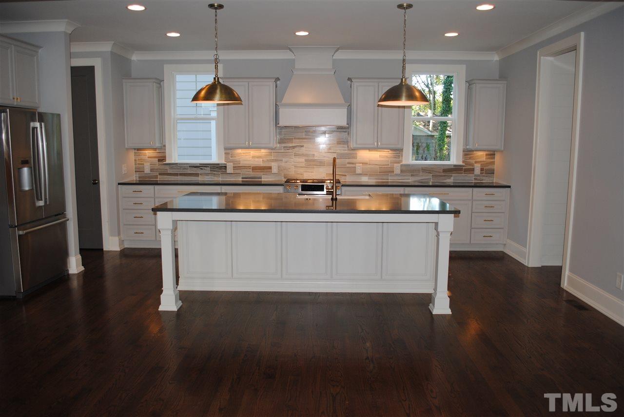 110 Revival Way Raleigh, NC 27608 - Photo 5 of 25 a kitchen with stainless steel appliances granite countertop a stove a sink and a refrigerator