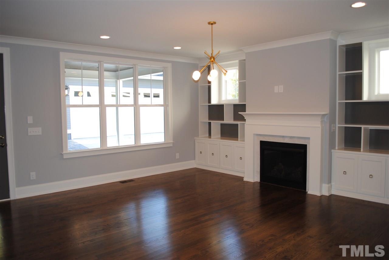 110 Revival Way Raleigh, NC 27608 - Photo 7 of 25 a view of a room with wooden floors fireplace and windows
