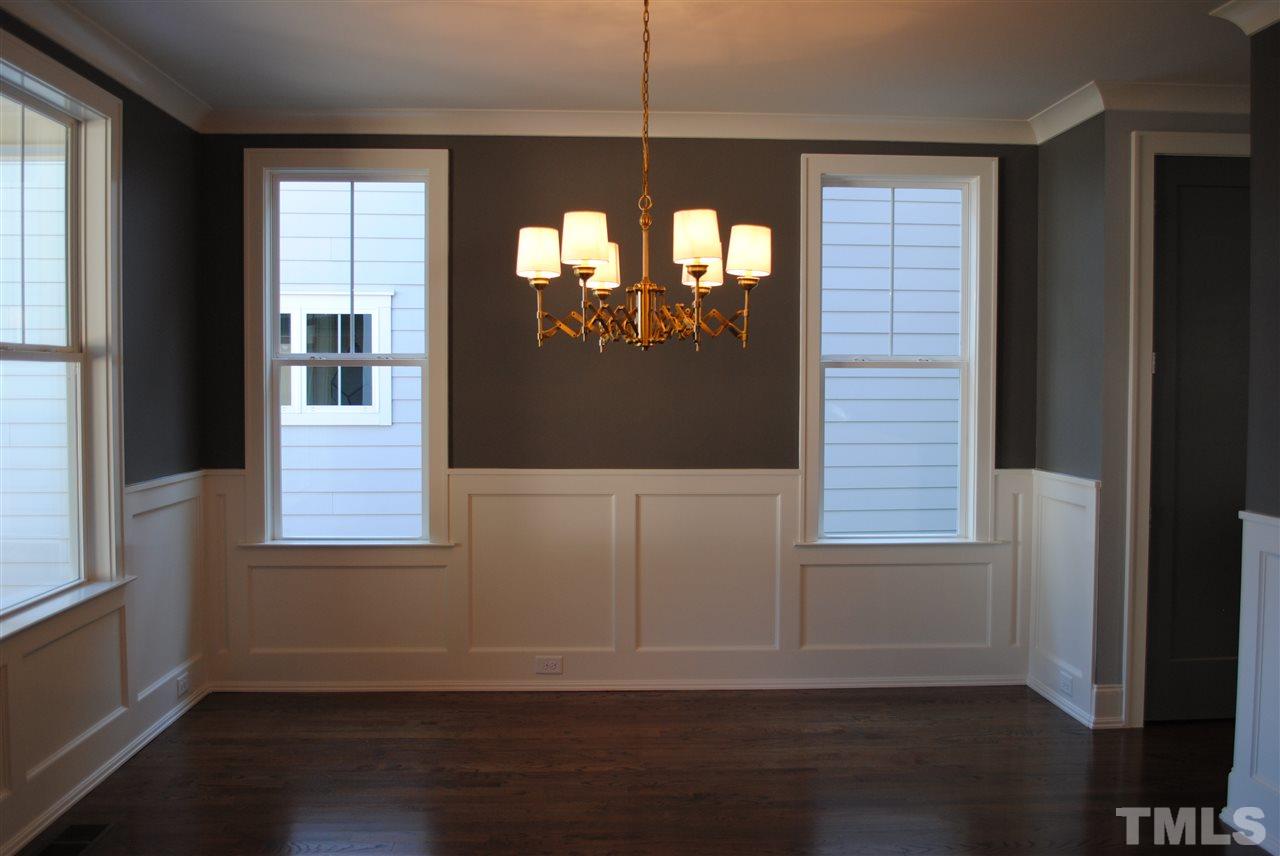 110 Revival Way Raleigh, NC 27608 - Photo 8 of 25 an empty room with wooden floor and windows