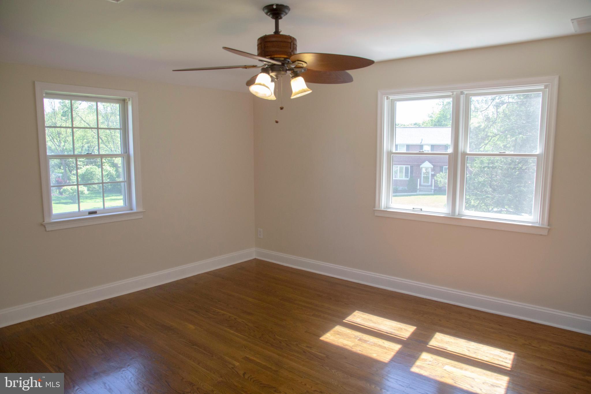 584 Valley View Road Springfield, PA 19064 - Photo 18 of 38 a view of empty room with wooden floor and fan