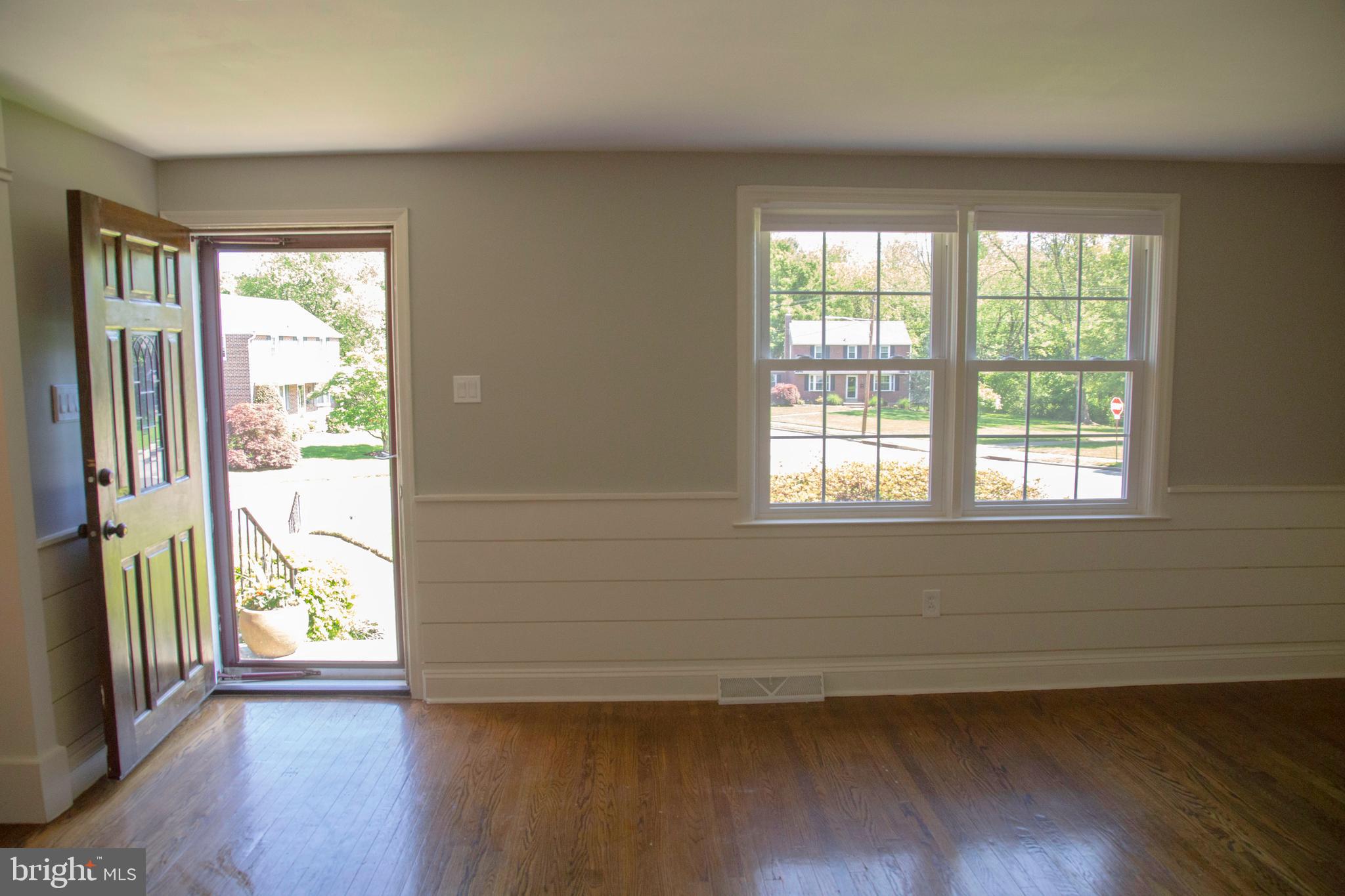 584 Valley View Road Springfield, PA 19064 - Photo 3 of 38 a view of an empty room with wooden floor and a window