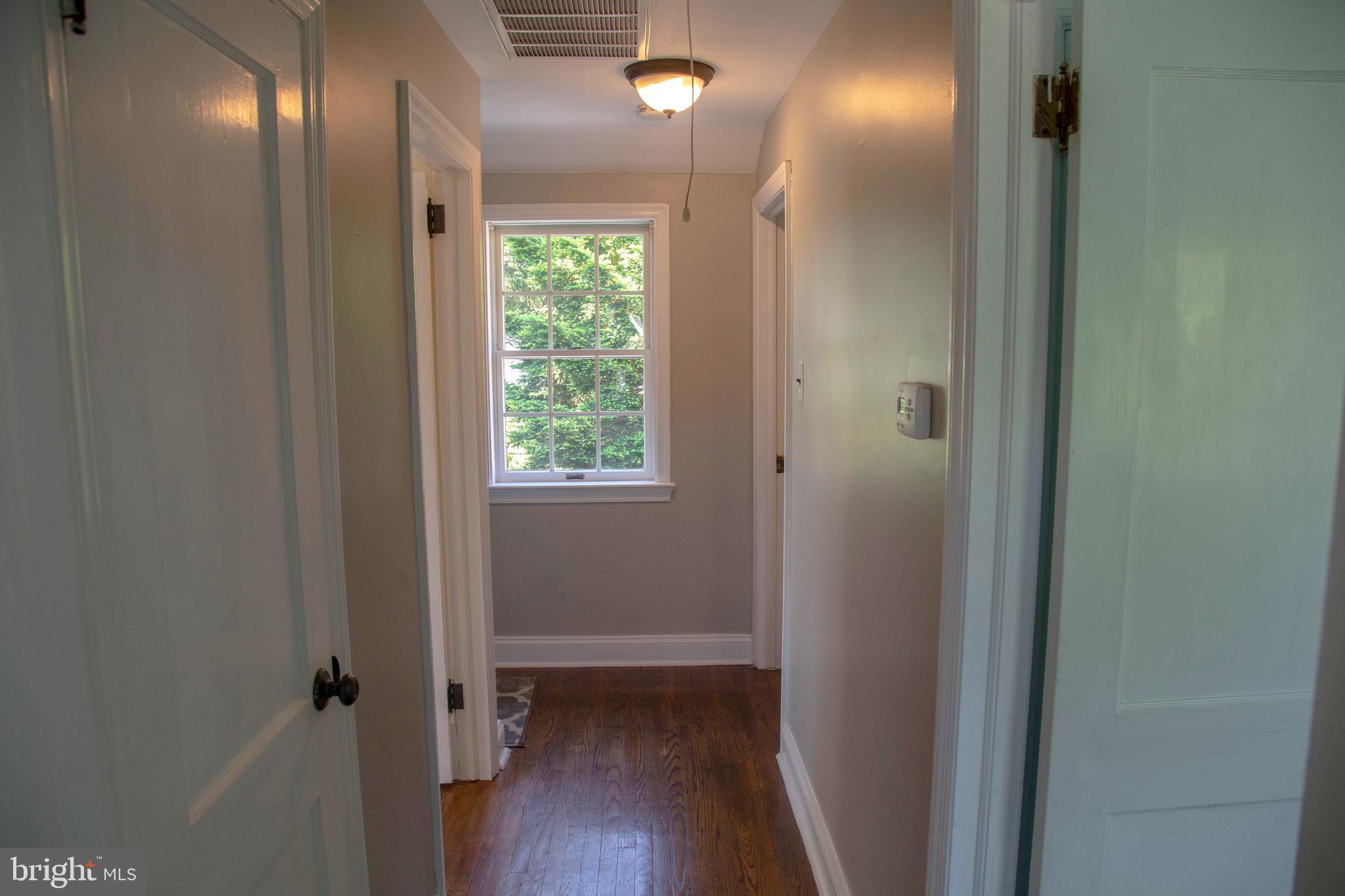 584 Valley View Road Springfield, PA 19064 - Photo 22 of 38 a view of a hallway with wooden floor