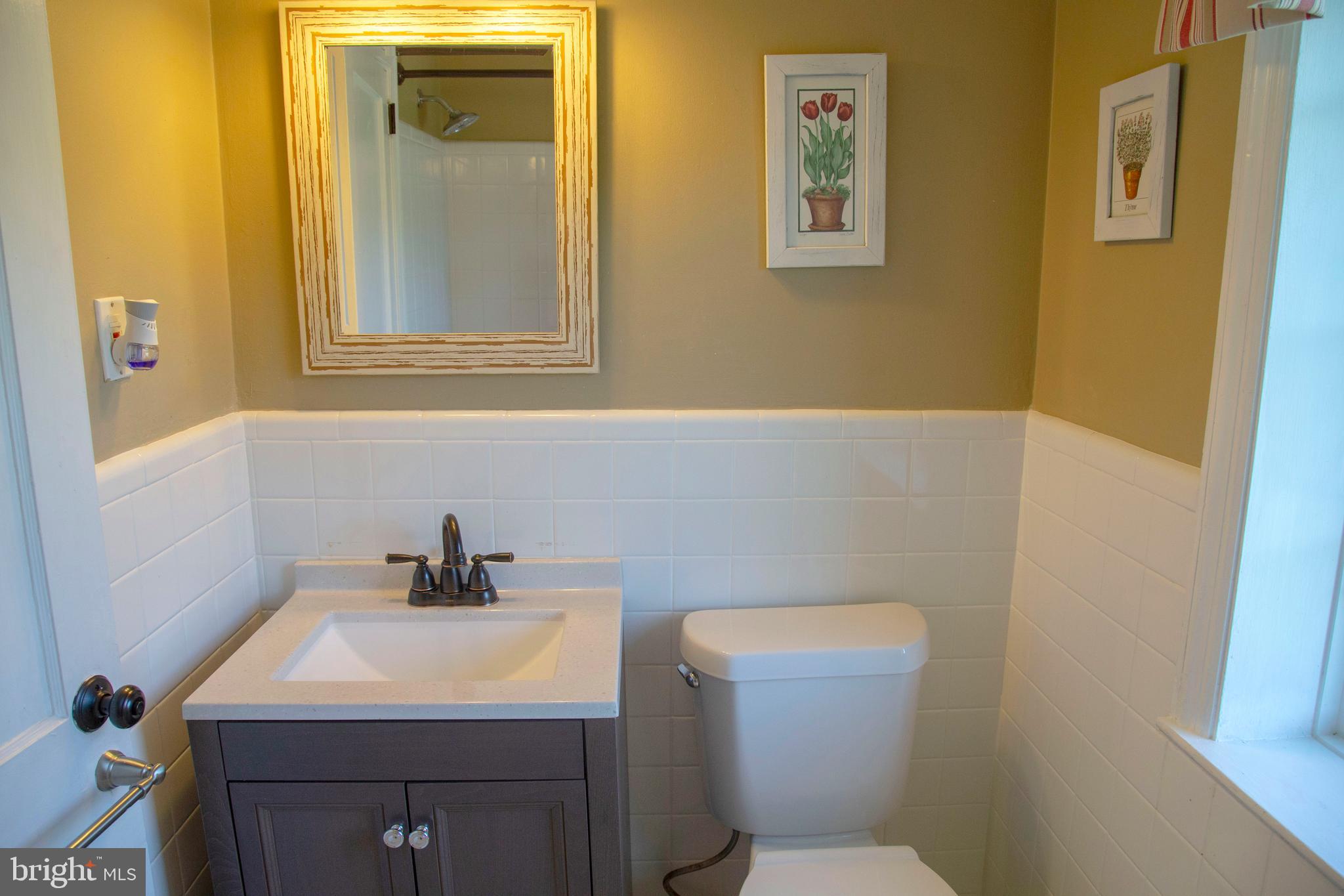 584 Valley View Road Springfield, PA 19064 - Photo 24 of 38 a bathroom with a sink mirror and toilet