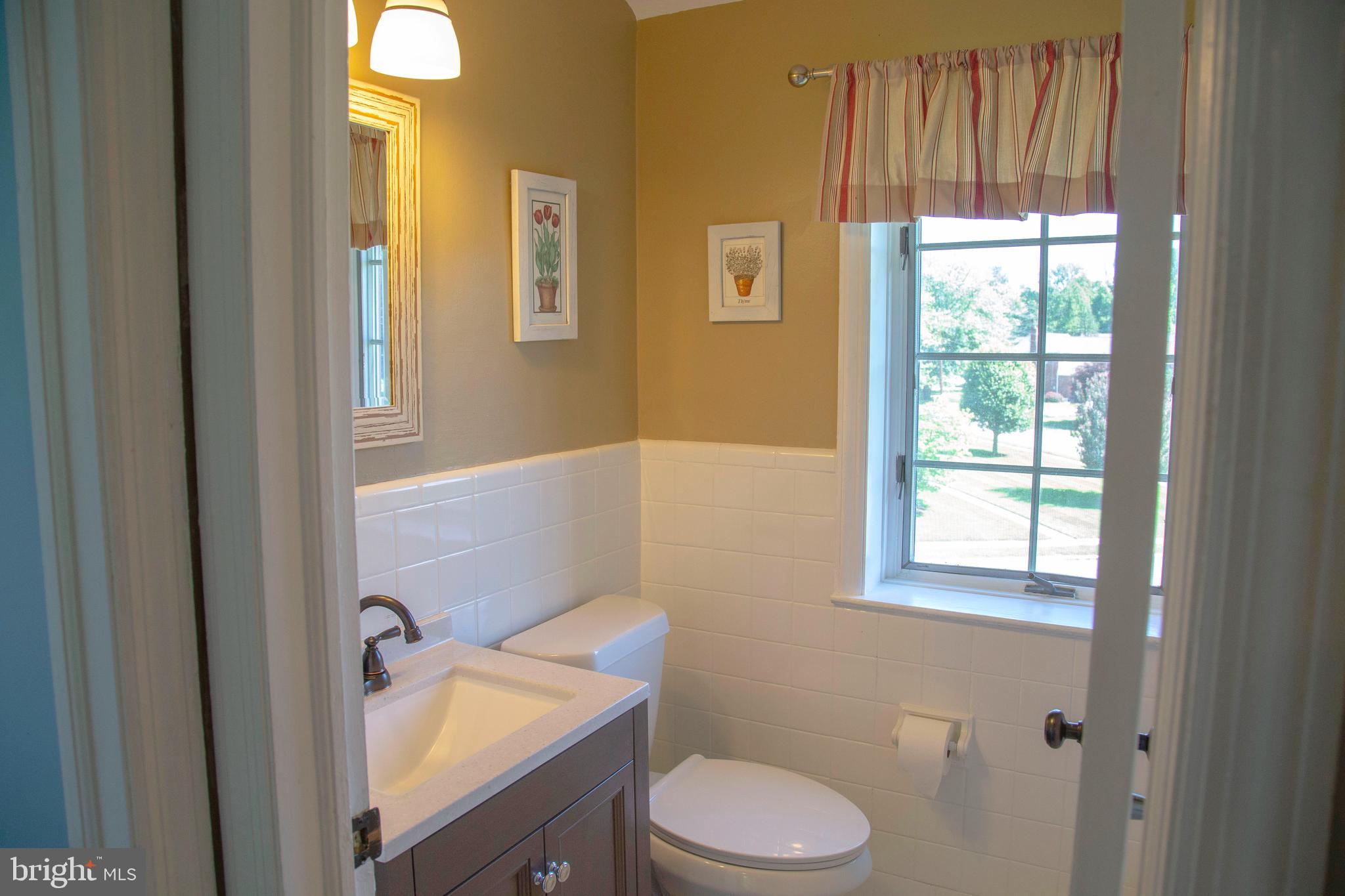 584 Valley View Road Springfield, PA 19064 - Photo 25 of 38 a bathroom with a toilet a sink and a window
