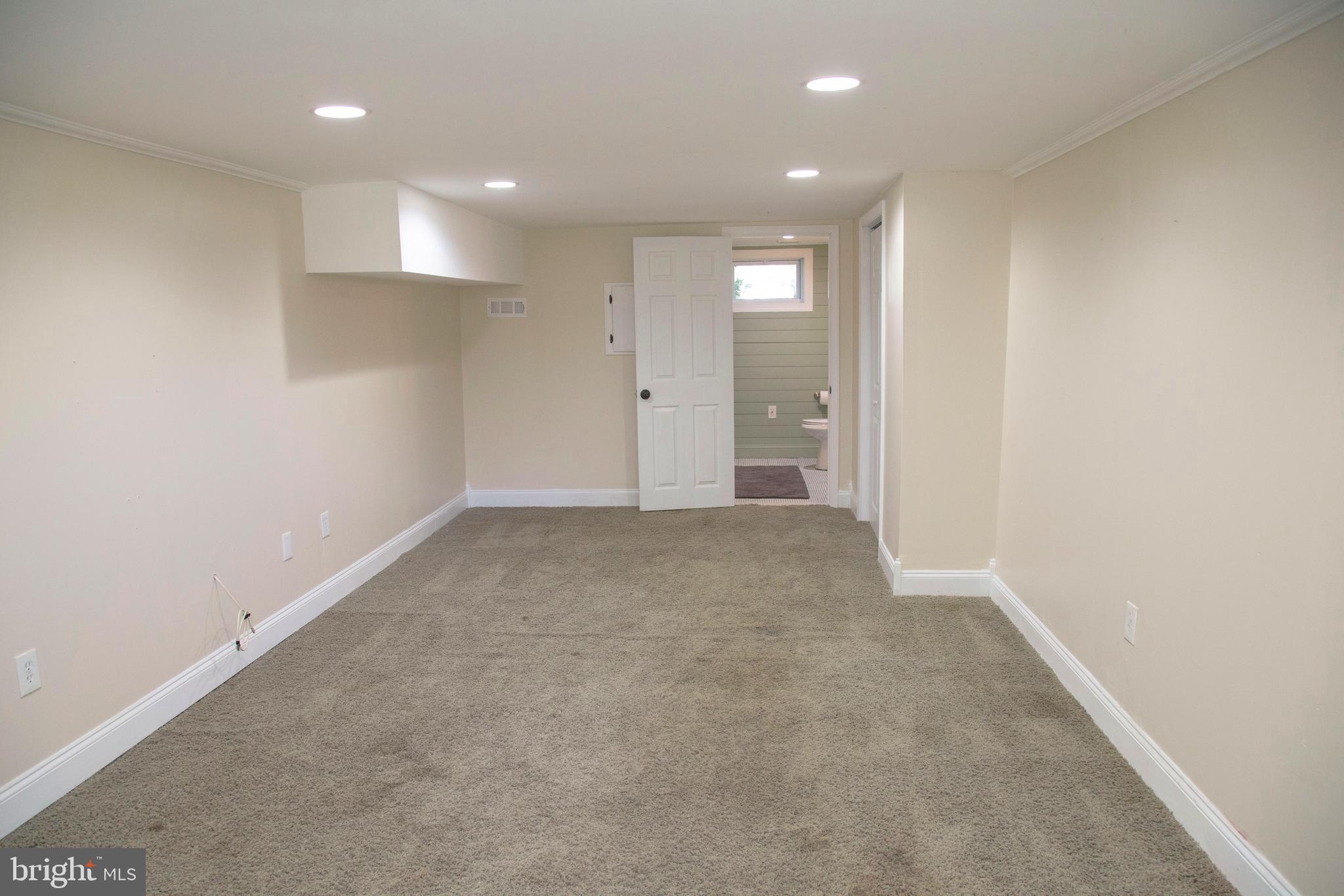 584 Valley View Road Springfield, PA 19064 - Photo 28 of 38 an empty room with windows and entrance to other room