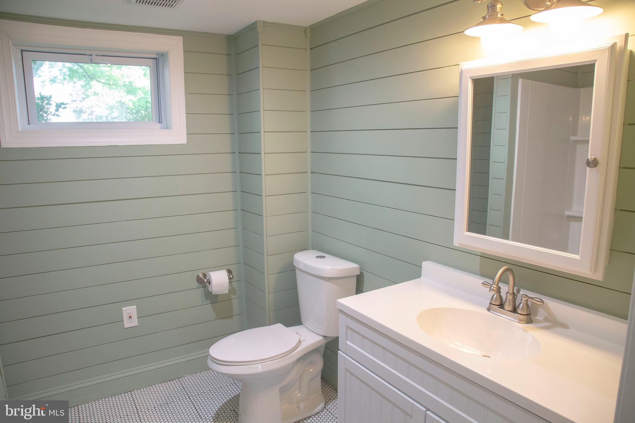 584 Valley View Road Springfield, PA 19064 - Photo 30 of 38 a bathroom with a toilet a sink and mirror
