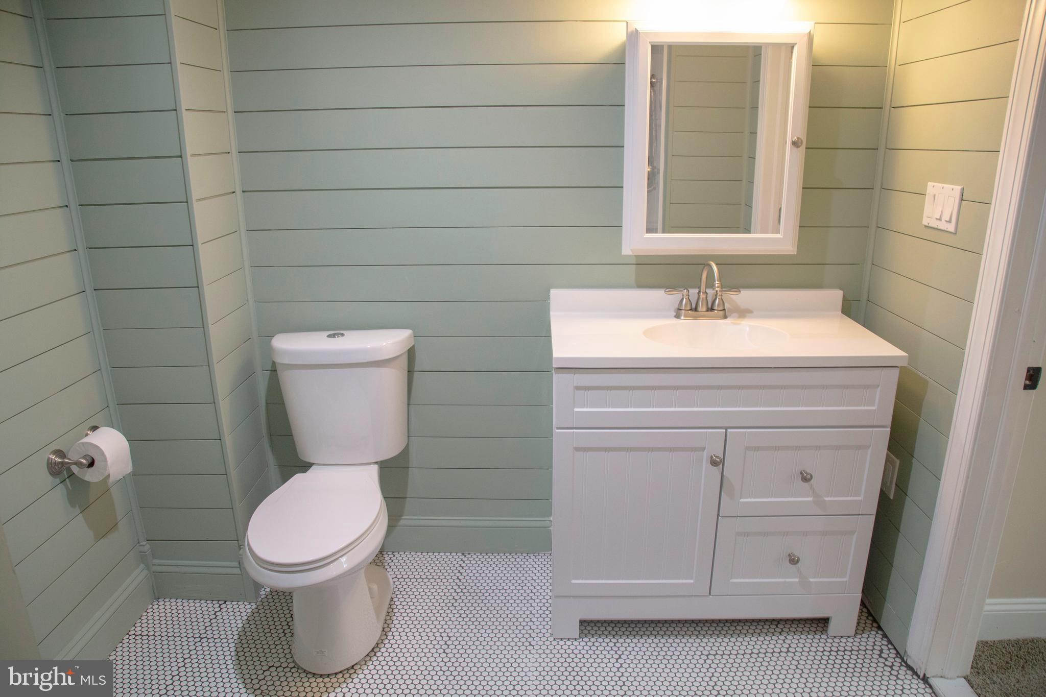 584 Valley View Road Springfield, PA 19064 - Photo 31 of 38 a bathroom with a toilet sink vanity and mirror