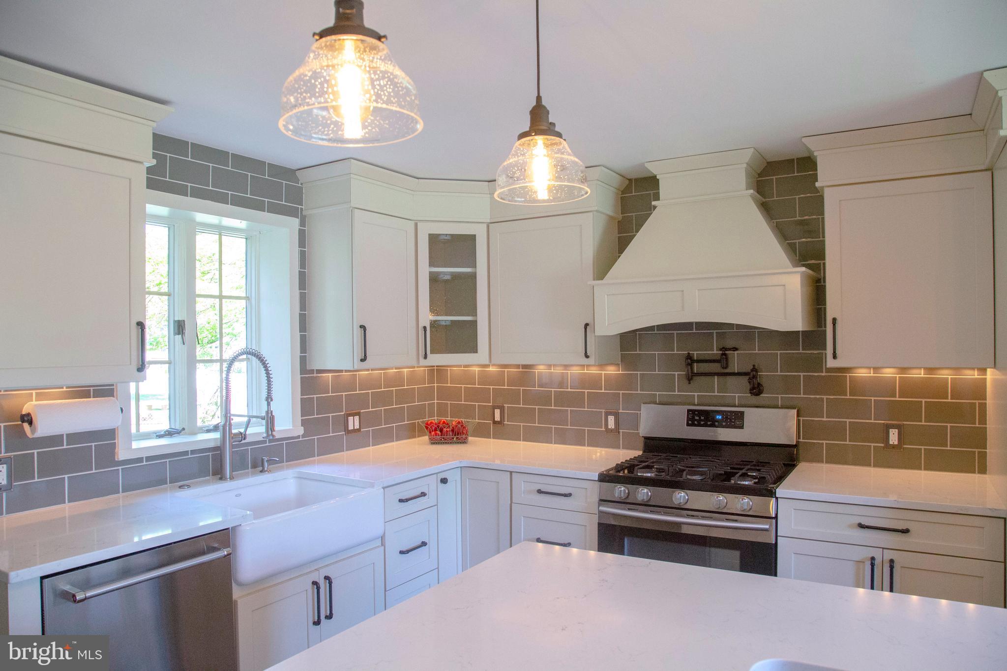 584 Valley View Road Springfield, PA 19064 - Photo 6 of 38 a kitchen with stainless steel appliances a stove a sink and a chandelier