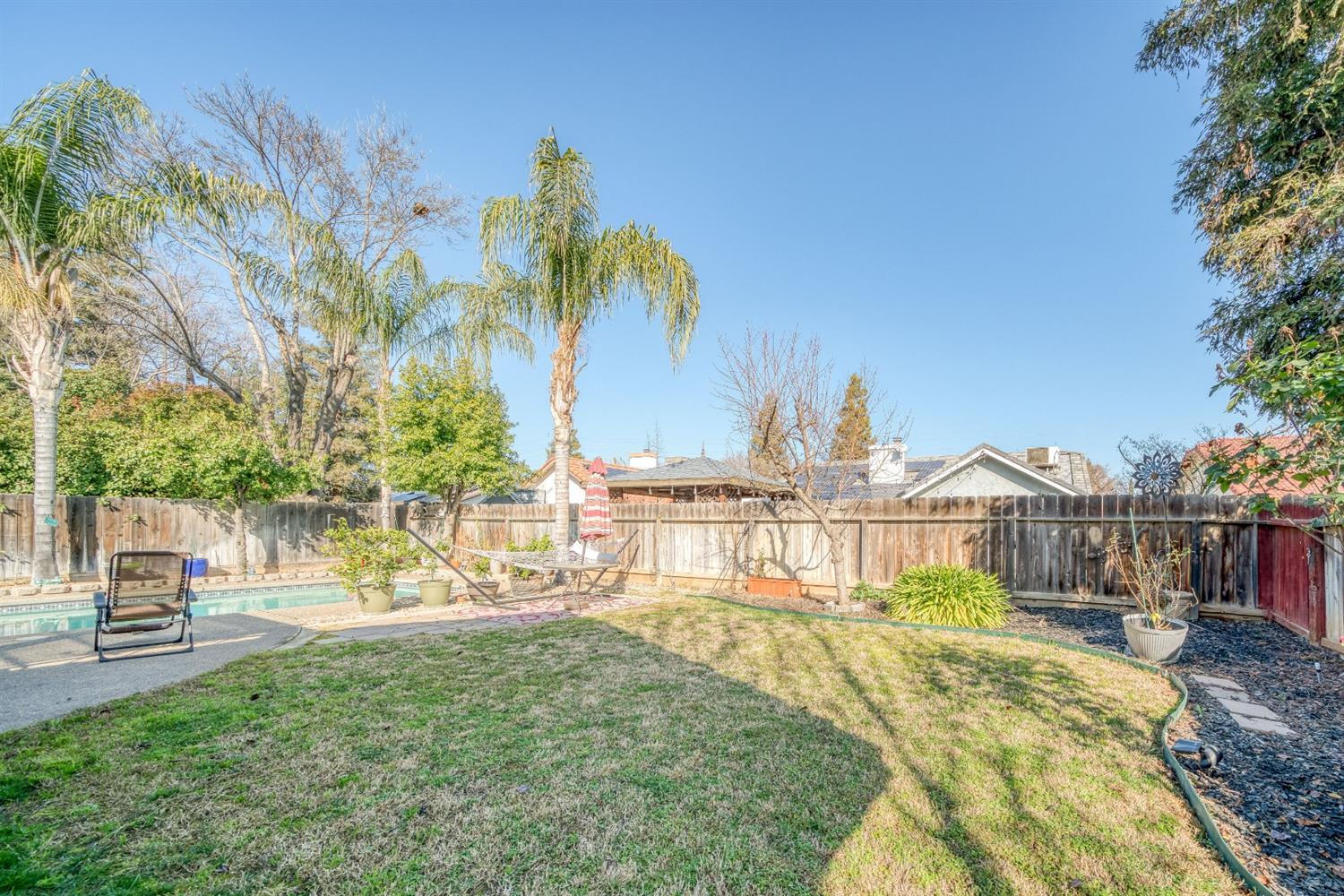 2505 Stuart Avenue Clovis, CA 93611 - Photo 19 of 23 a view of a swimming pool with a garden