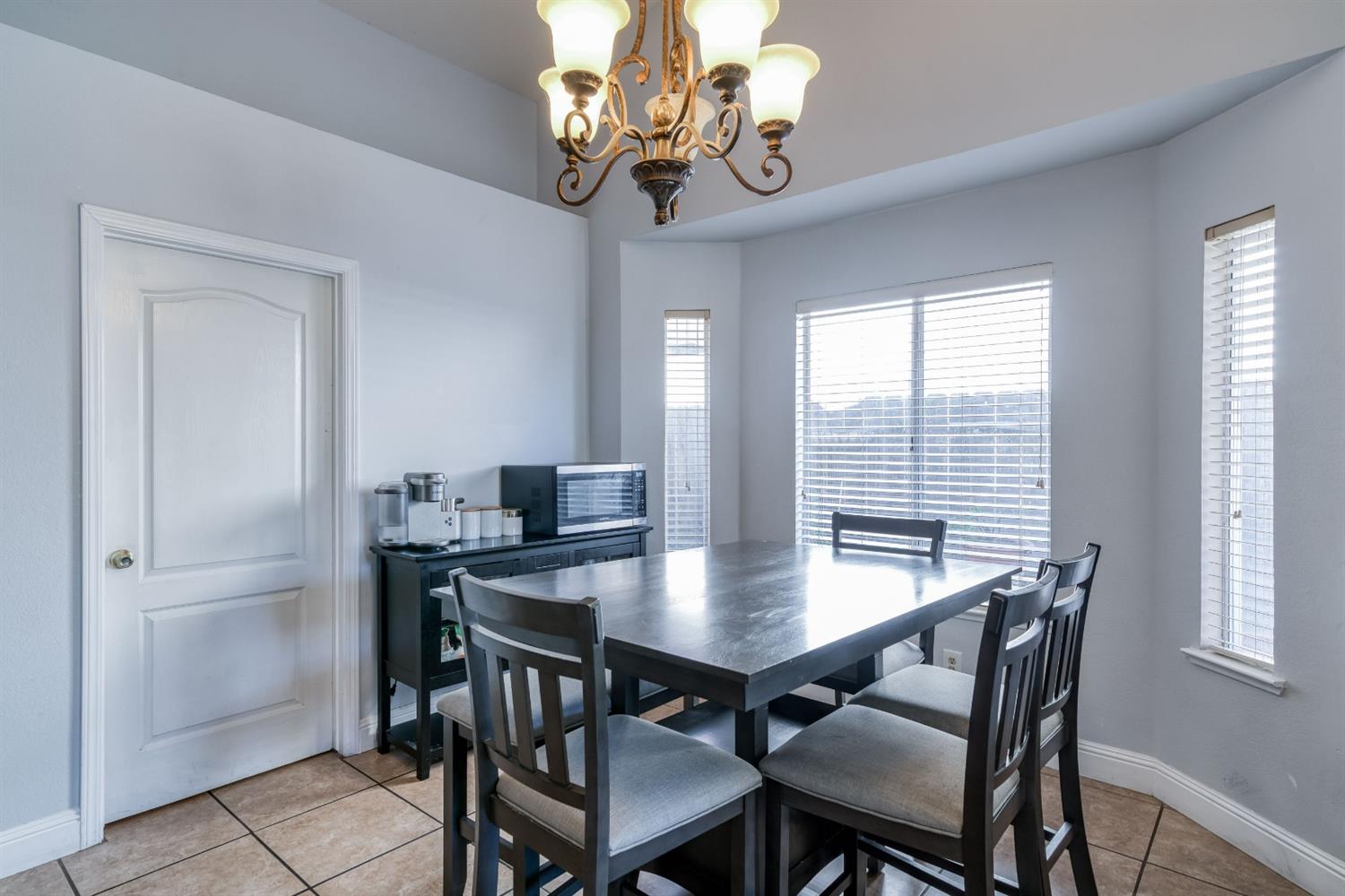 2505 Stuart Avenue Clovis, CA 93611 - Photo 5 of 23 a view of a dining room with a table and chairs