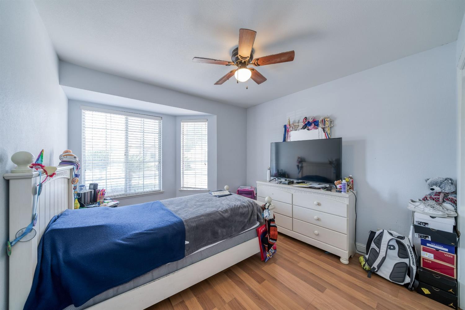 2505 Stuart Avenue Clovis, CA 93611 - Photo 9 of 23 a bedroom with a bed and a flat screen tv