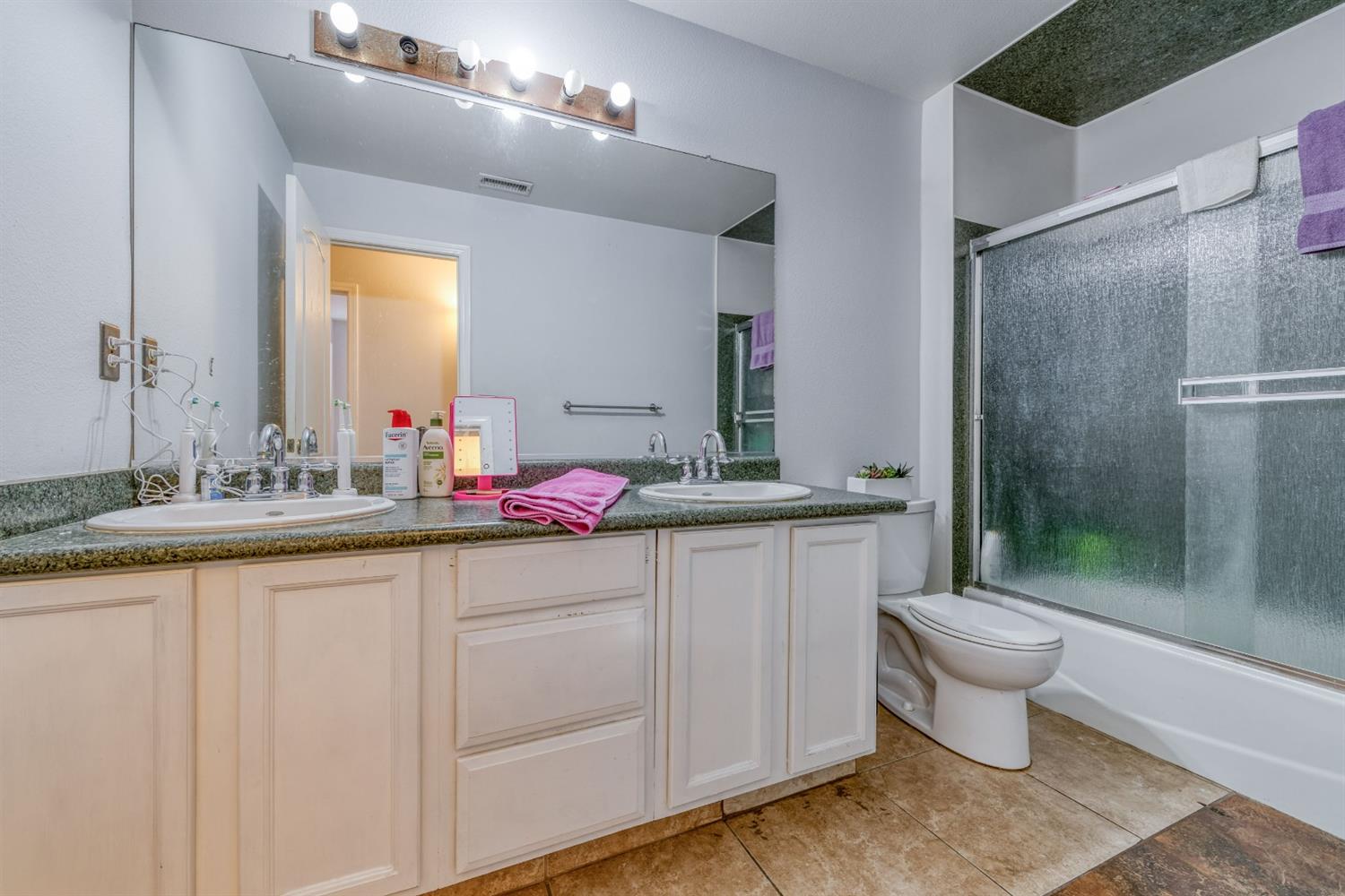 2505 Stuart Avenue Clovis, CA 93611 - Photo 10 of 23 a bathroom with a sink and a mirror