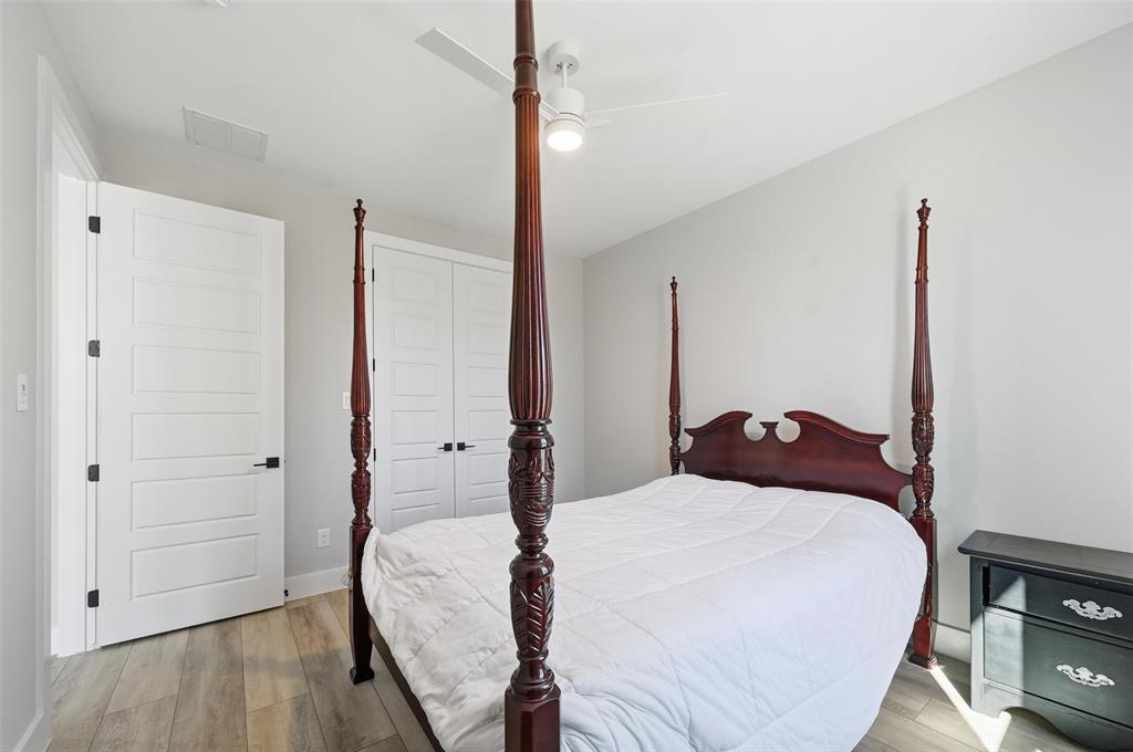 7733 Indian Ridge Trail Dallas, TX 75232 - Photo 14 of 30 a bedroom with a bed and a closet