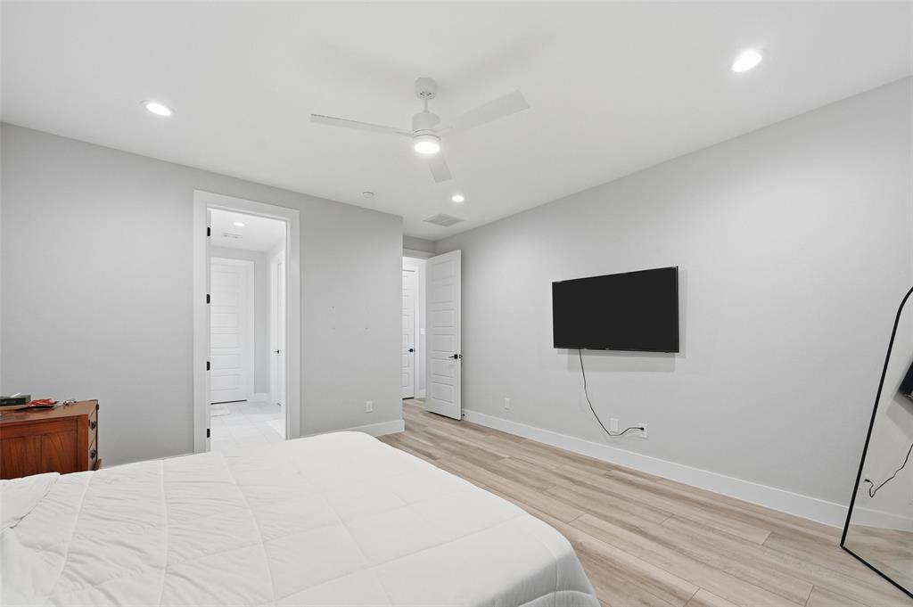 7733 Indian Ridge Trail Dallas, TX 75232 - Photo 16 of 30 a bedroom with a bed and a flat screen tv