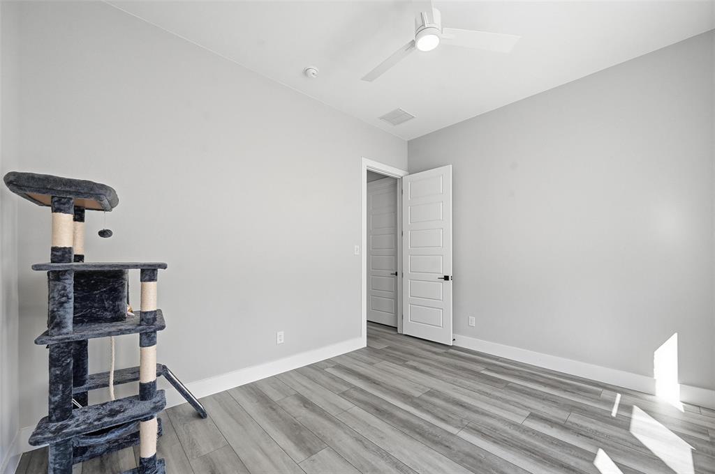 7733 Indian Ridge Trail Dallas, TX 75232 - Photo 7 of 30 wooden floor in an empty room