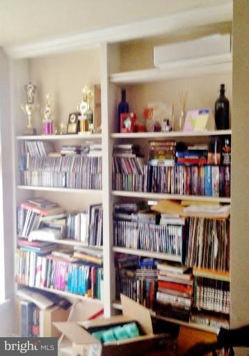 2012 O Street Northwest, Unit 42 Washington, DC 20036 - Photo 19 of 22 a bookshelf with wooden floor and a book shelf