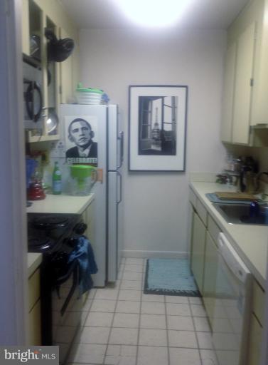2012 O Street Northwest, Unit 42 Washington, DC 20036 - Photo 20 of 22 a kitchen with stainless steel appliances a stove and a refrigerator