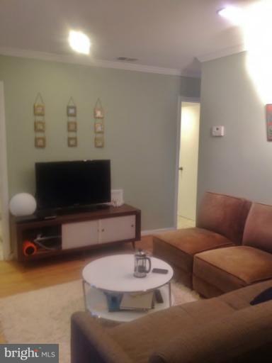 2012 O Street Northwest, Unit 42 Washington, DC 20036 - Photo 5 of 22 a living room with furniture and a flat screen tv