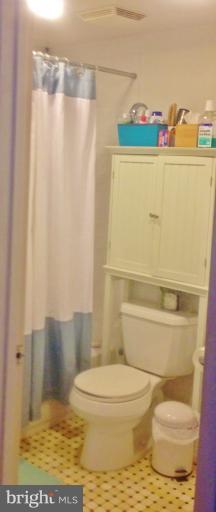 2012 O Street Northwest, Unit 42 Washington, DC 20036 - Photo 10 of 22 a bathroom with a toilet and a shower curtain