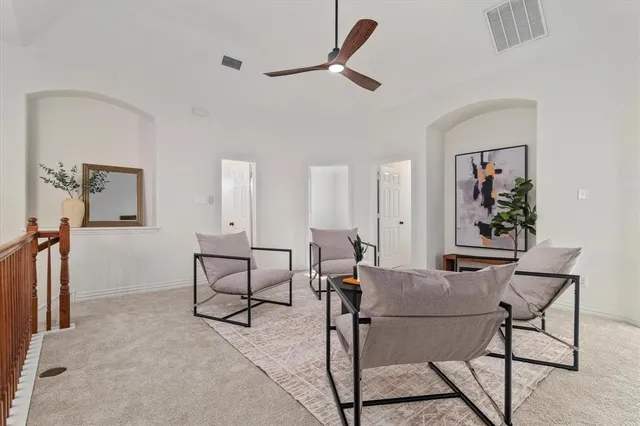 a view of a livingroom with furniture and a potted plant