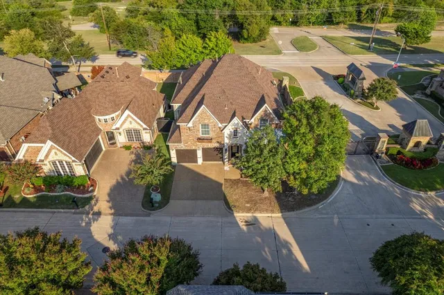 an aerial view of a house with yard