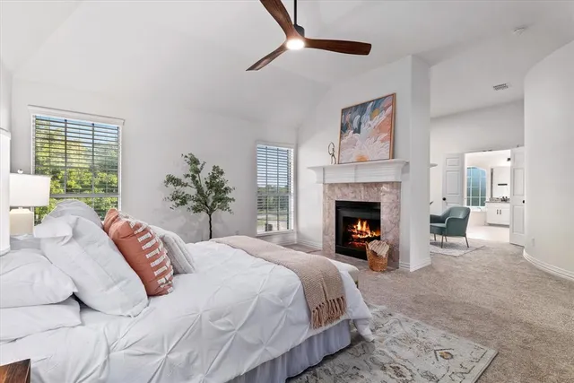 a bedroom with a large bed and a fireplace
