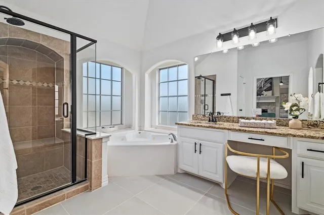 a large bathroom with a double vanity sink a mirror and shower