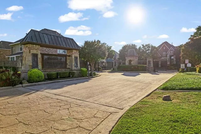 a view of a white house with a yard and potted plants