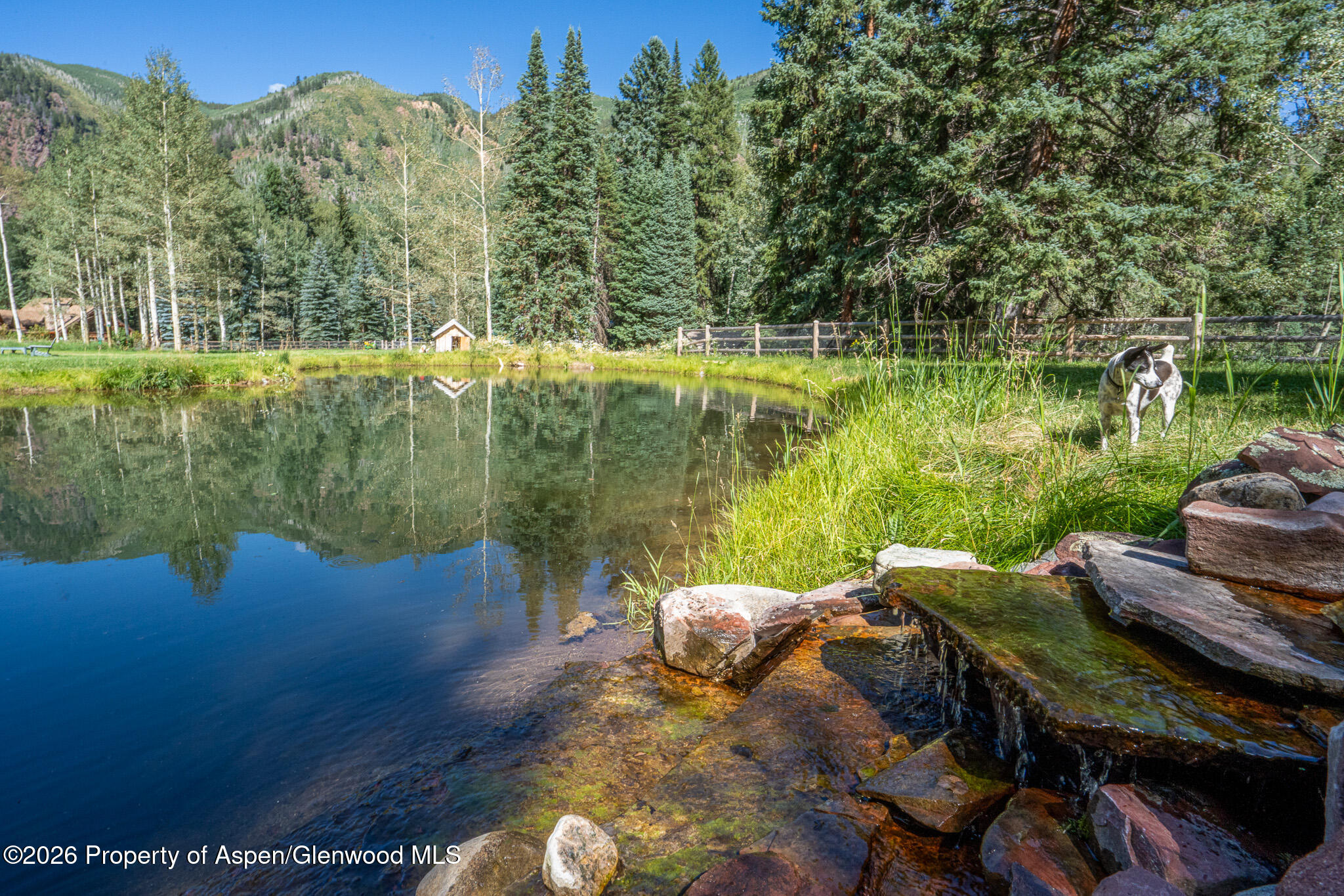 285 Conundrum Creek Road Aspen, CO 81611 - Photo 10 of 35 a view of a lake with couches in the patio