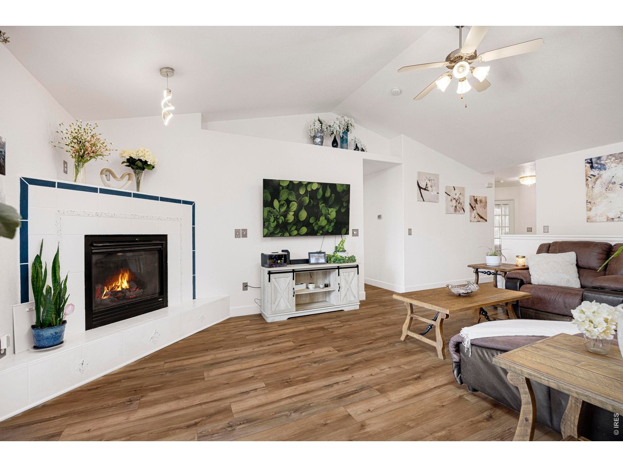 148 Beacon Way Windsor, CO 80550 - Photo 35 of 36 Alternate living room view showcasing the fireplace feature wall, vaulted ceilings, open floor plan, and spacious layout ideal for everyday living and entertaining.