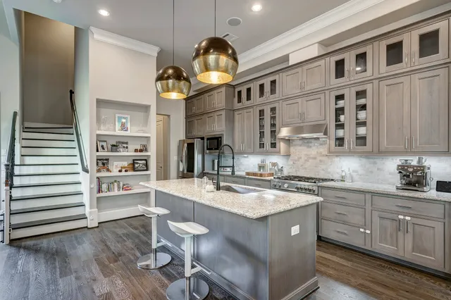 a kitchen with a sink cabinets and wooden floor
