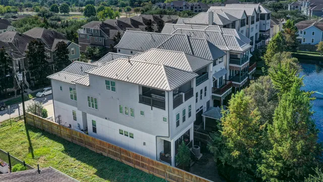 an aerial view of a house with a yard from a balcony