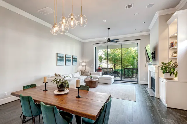 a view of a dining room with furniture a chandelier and wooden floor