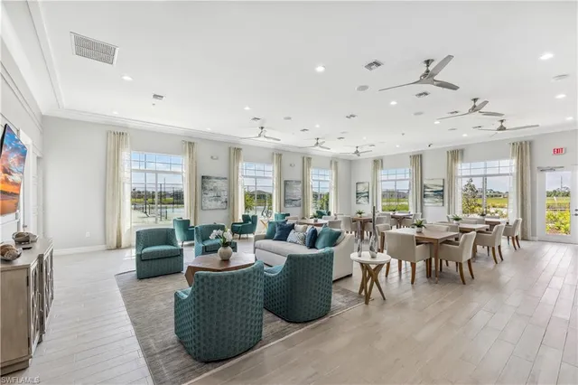a living room with fireplace furniture and a large window